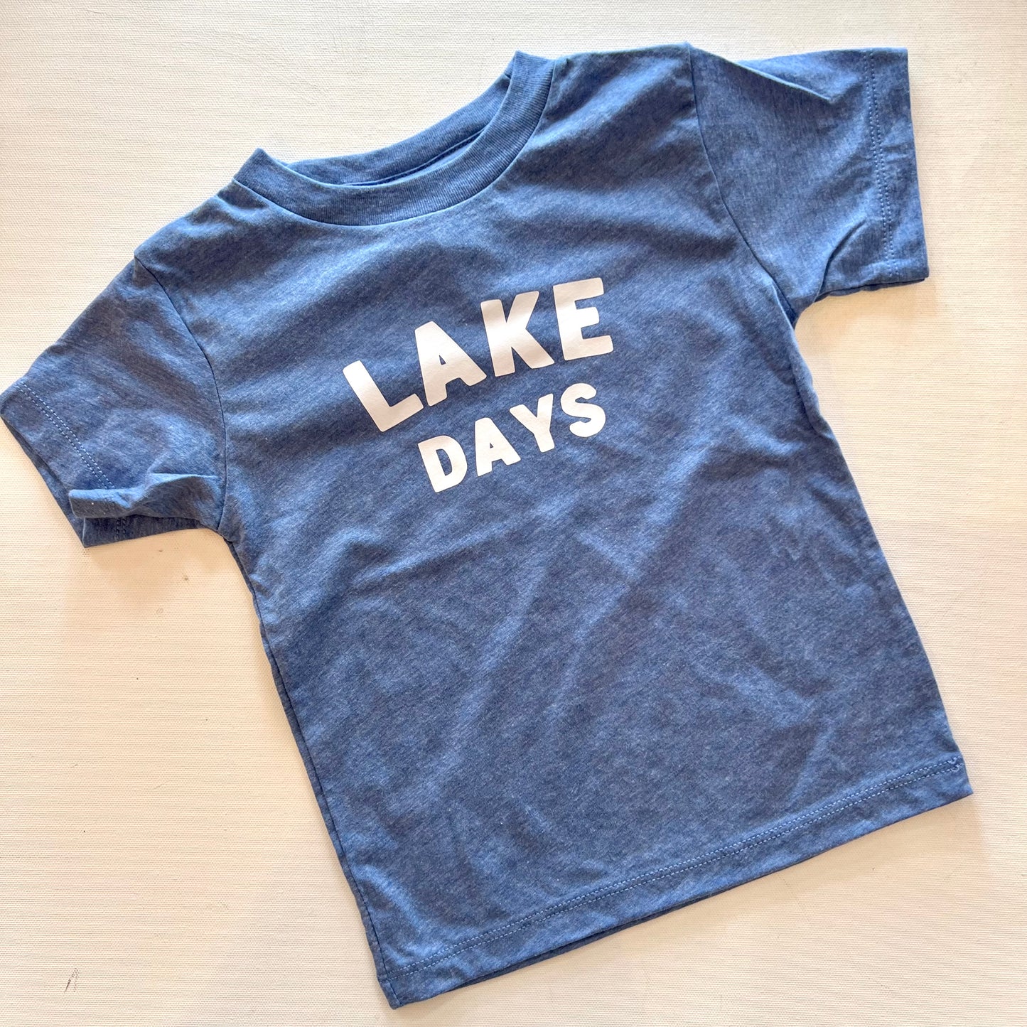 Kids clothing. Graphic t-shirt. Blue color. Lake days.