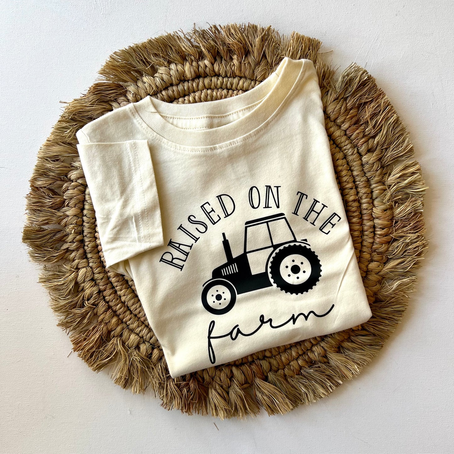 Kids clothing. Graphic t-shirt. Raised on the farm.